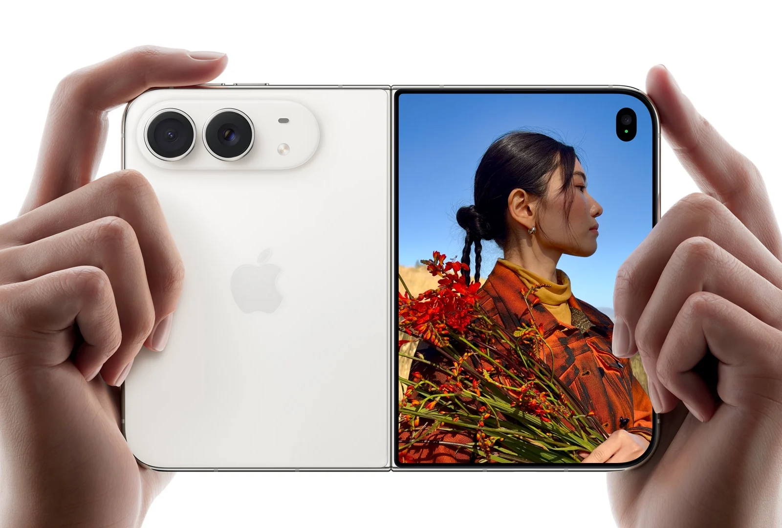 Hands holding the iPhone Duo in opened form, showing camera and external display