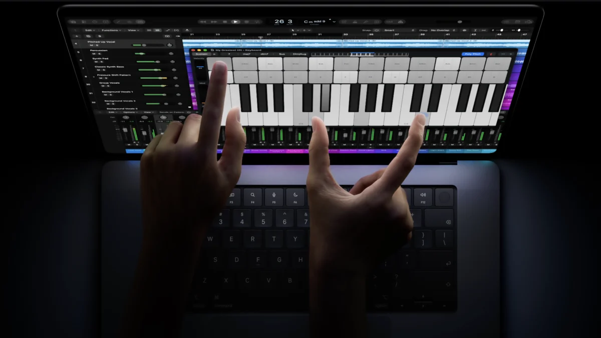 hands using touch on the new MacBook Pro PROLED