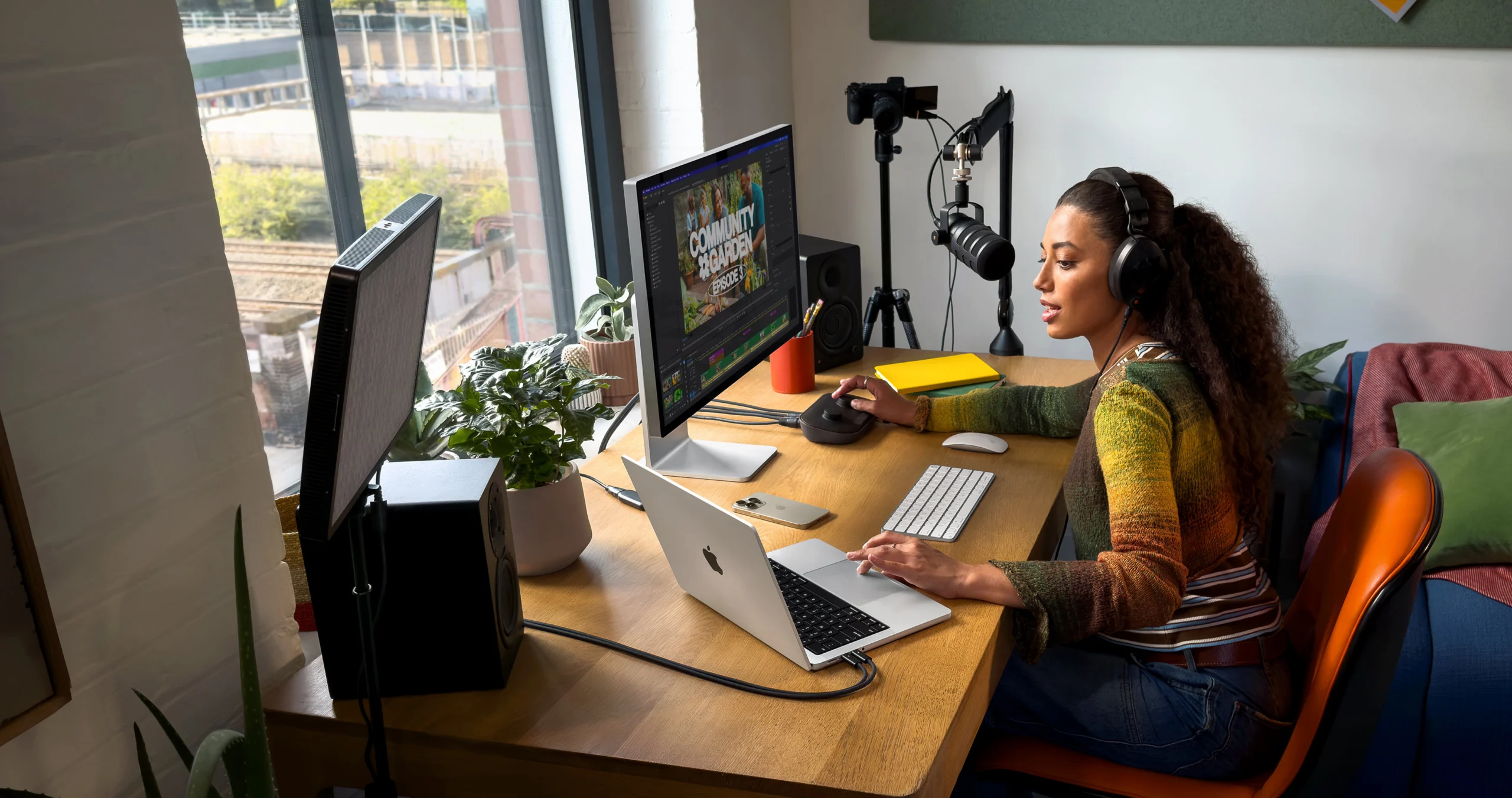 A girl using the MacBook Pro and iMac